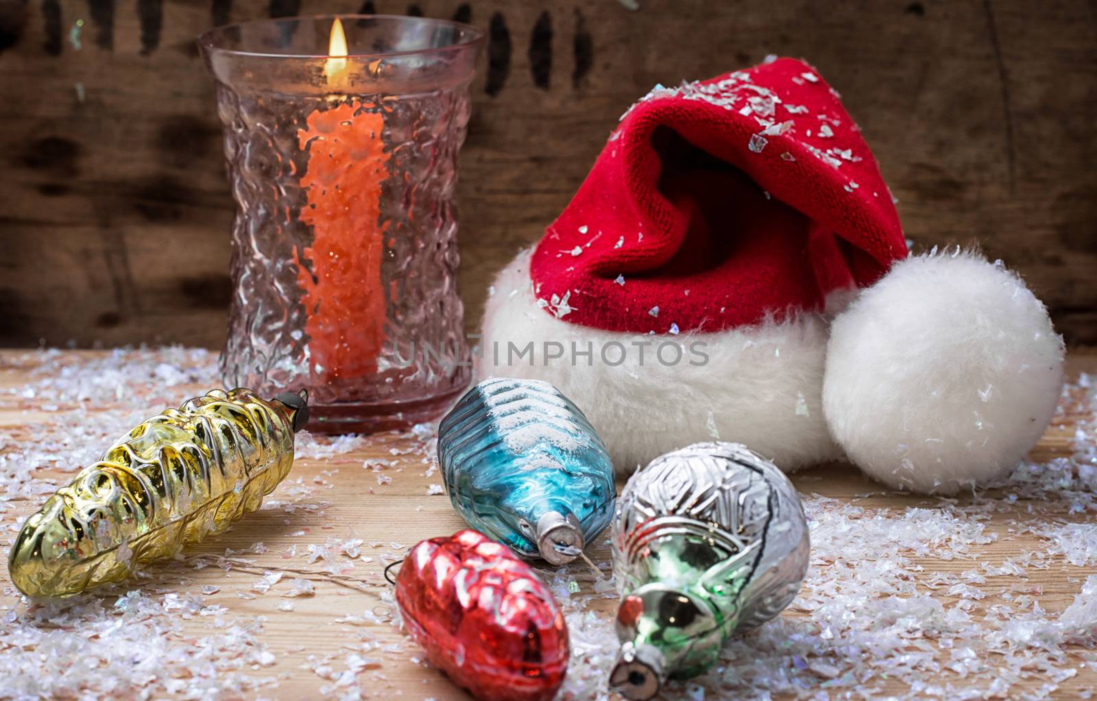 festive decoration with Christmas hat and a burning candle