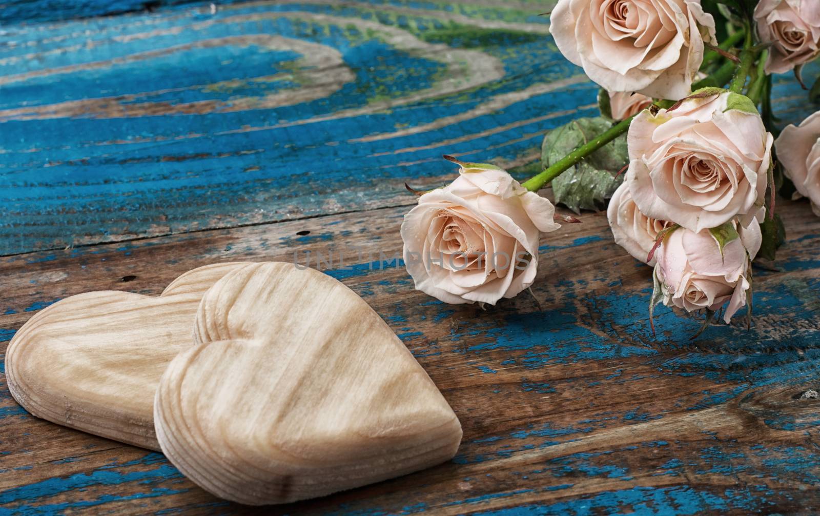 two wooden heart and bouquet of fresh cut roses