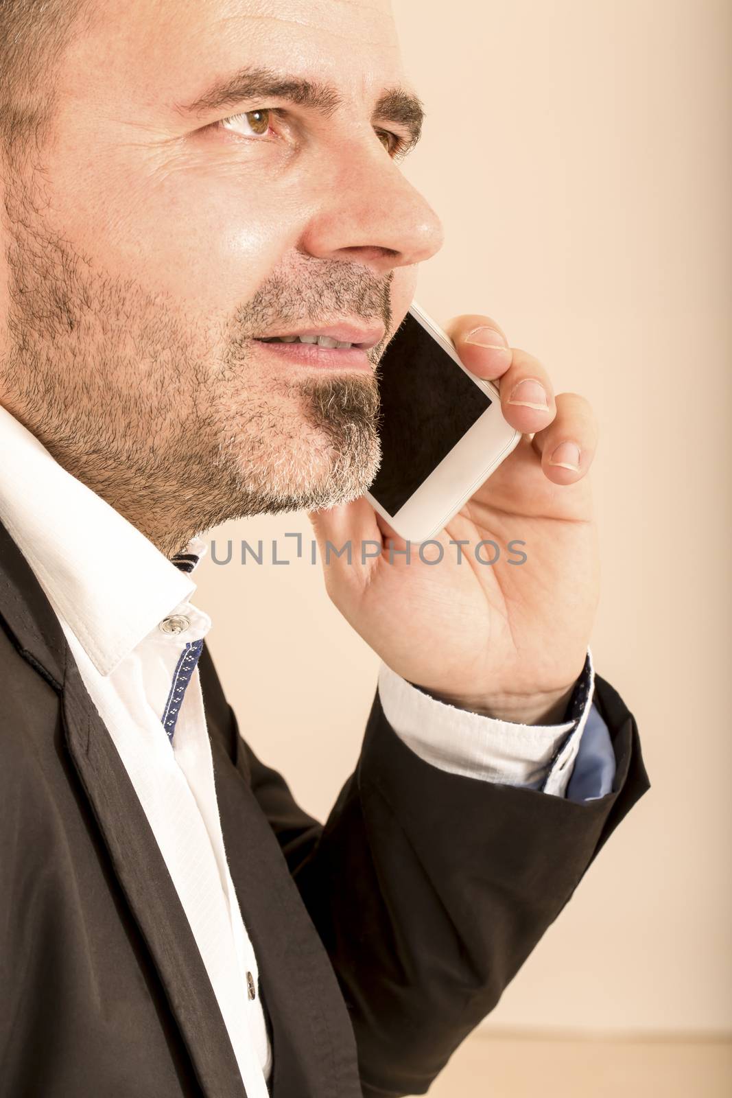 Attractive man talking on  telephone by CatherineL-Prod