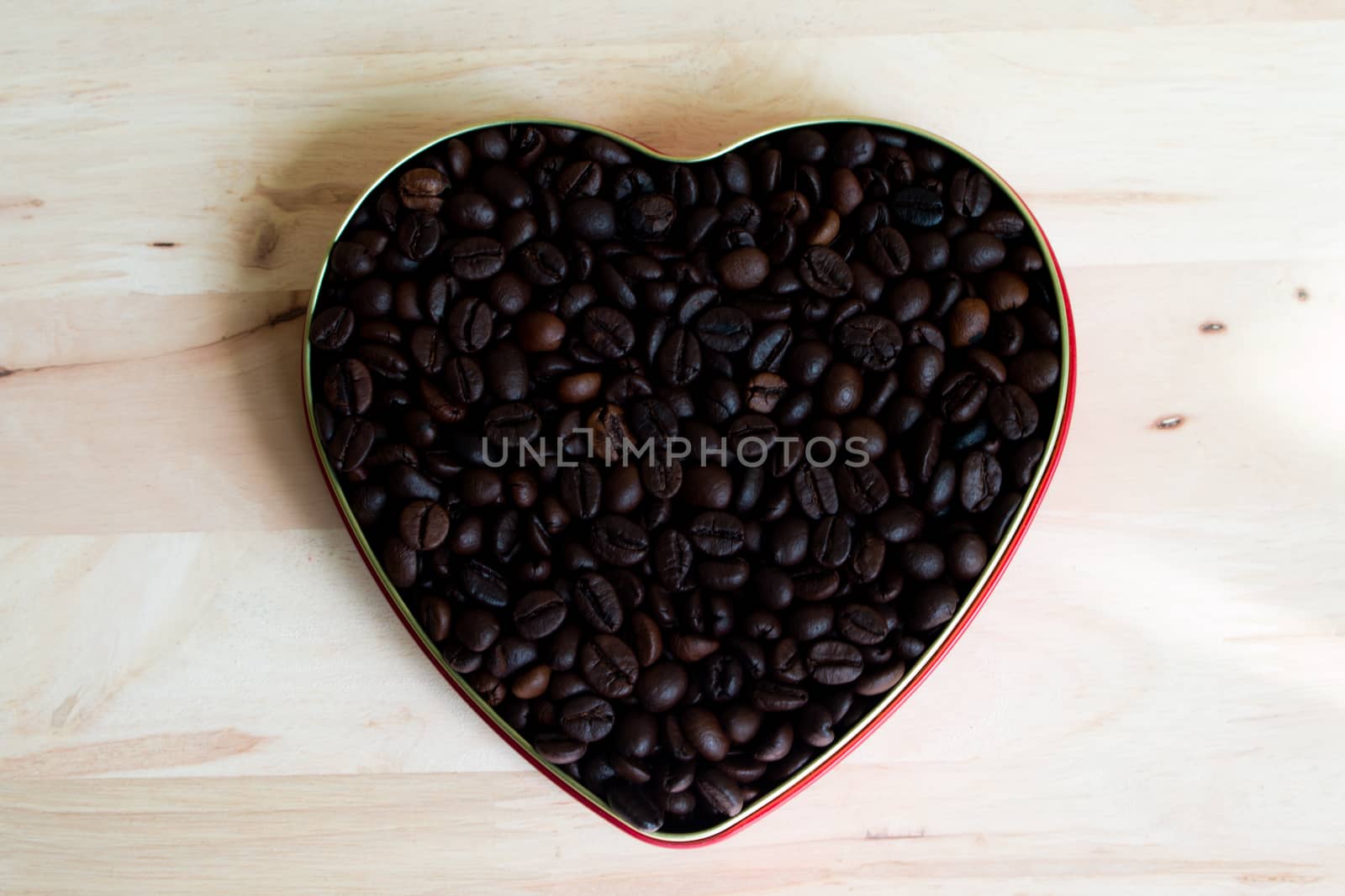 Coffee beans surrounded Chocolate wrapper on Valentine's Day, Wood background. by N_u_T