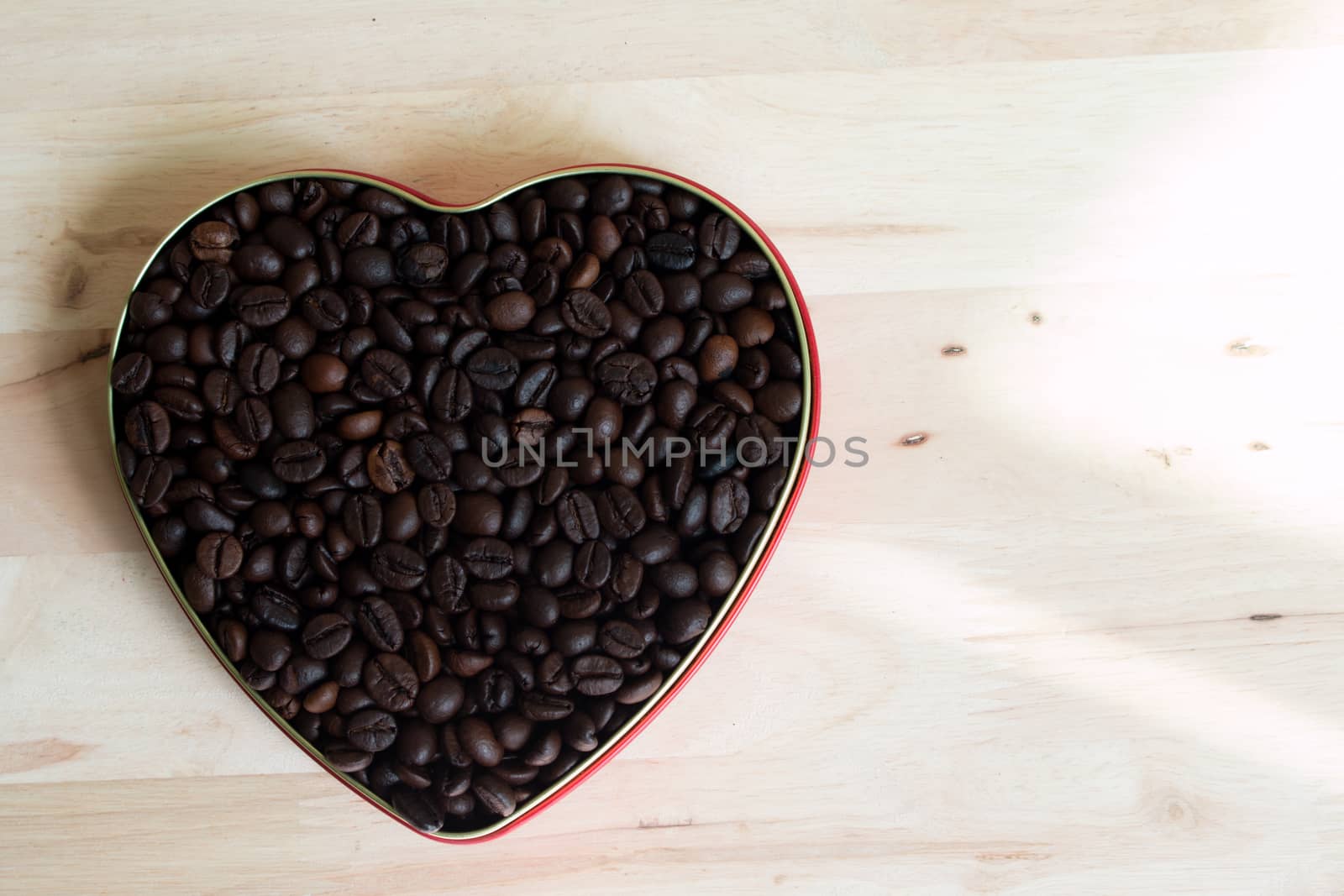 Coffee beans in the heart on Valentine's Day, Wood background.