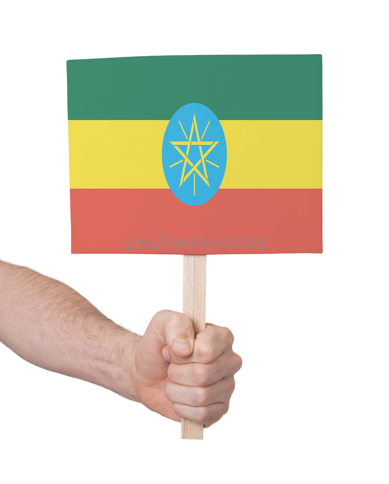 Hand holding small card - Flag of Ethiopia by michaklootwijk