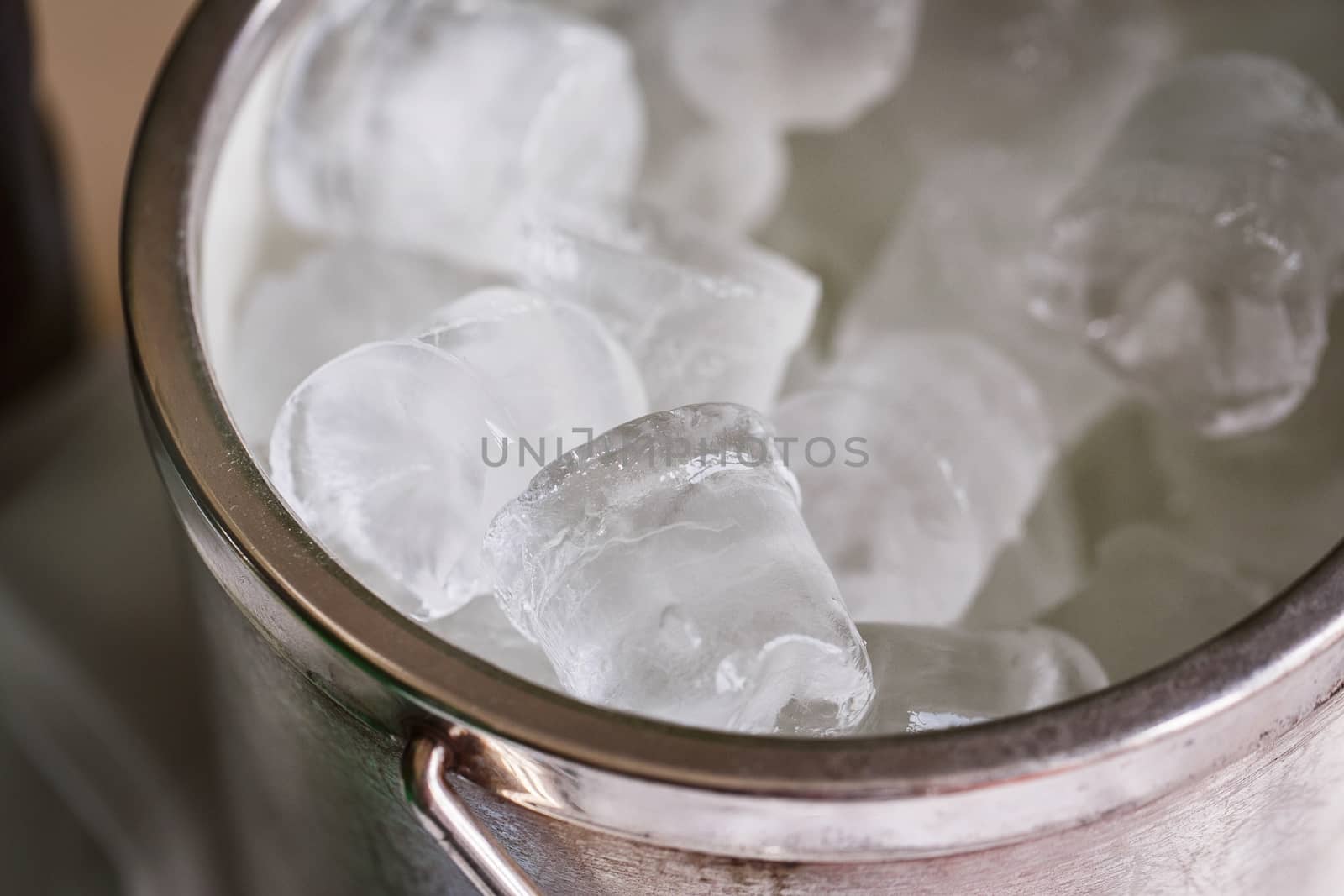 Bucket with cold ice cubes on the wedding 