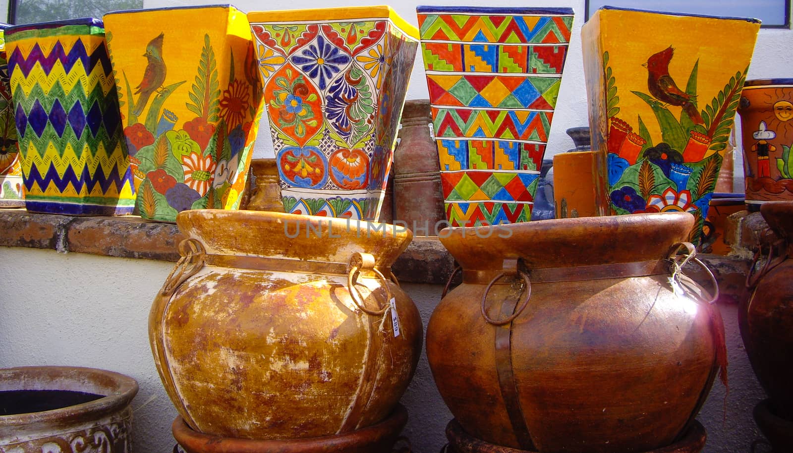 Mexican pots stacked in market by emattil