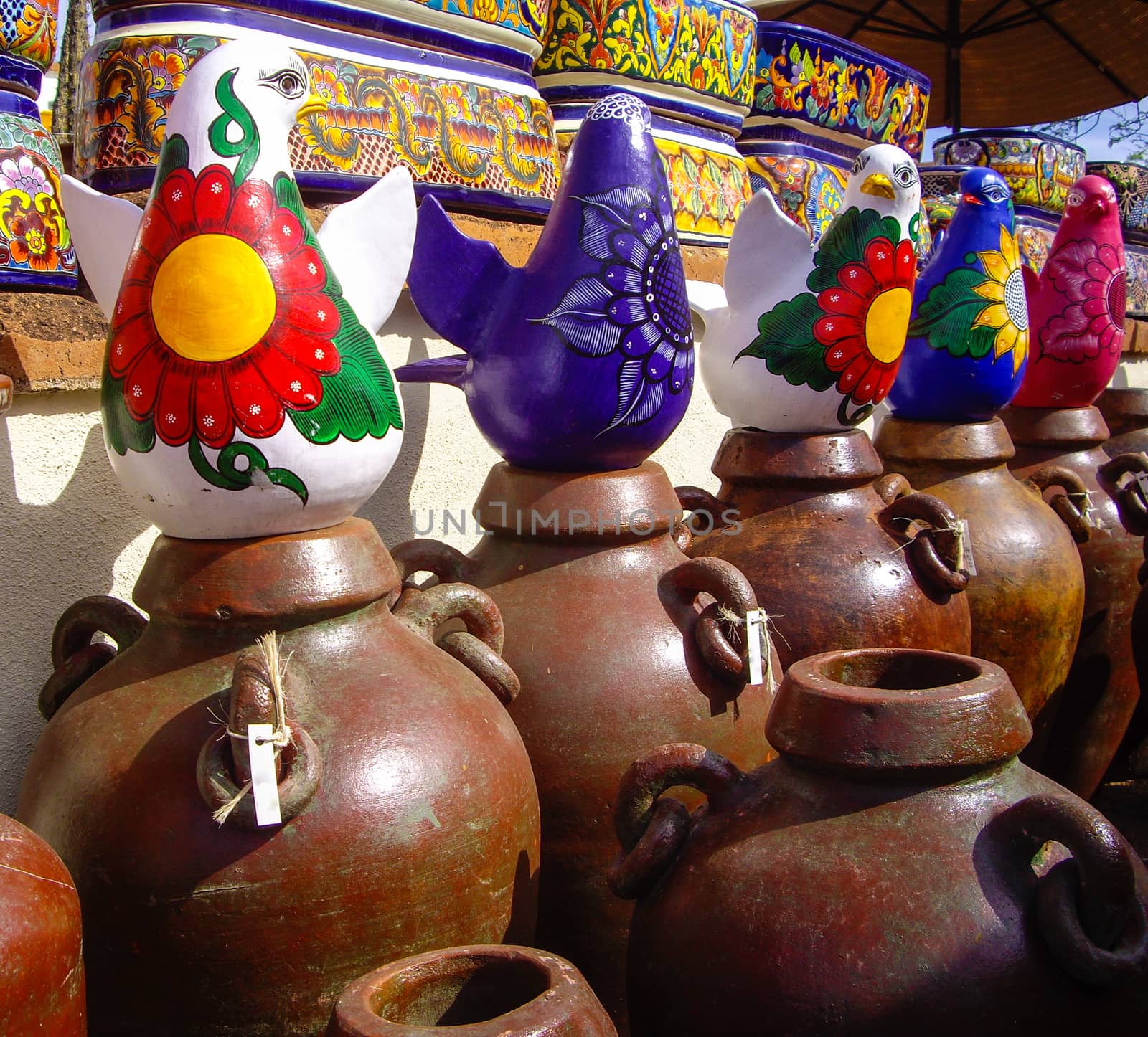 Colorful Mexican pottery and birds by emattil