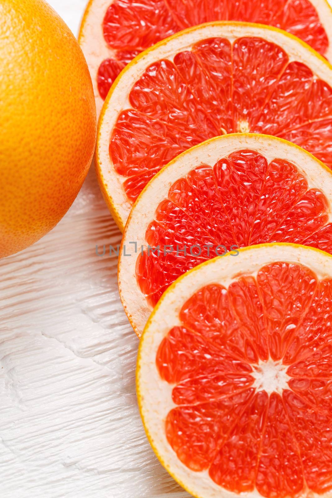 Fresh juicy grapefruit and round slices background
