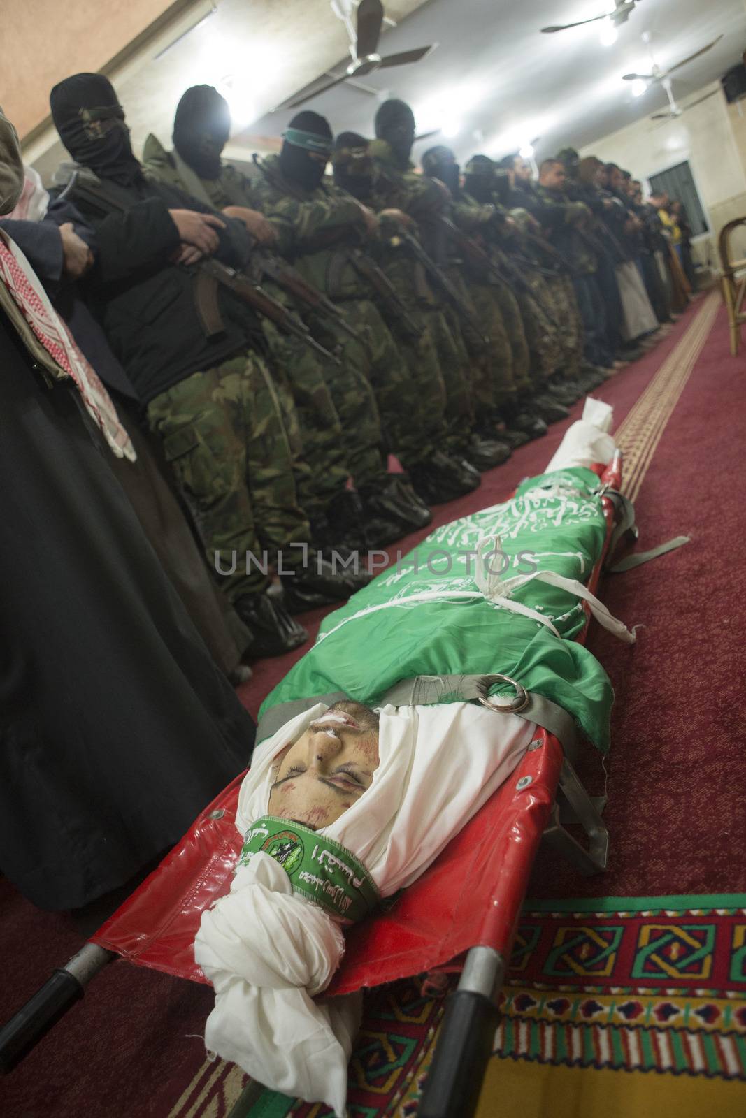 GAZA, Khan Yunis: [Warning: graphic content] The body of Marwan Maarouf is laid to rest by Hamas' Al-Qassam Brigades during a funeral service in Khan Yunis, the Gaza Strip on February 9, 2016. The 27-year-old man was reportedly killed in one of several recent tunnel collapses in southern Gaza since late January.