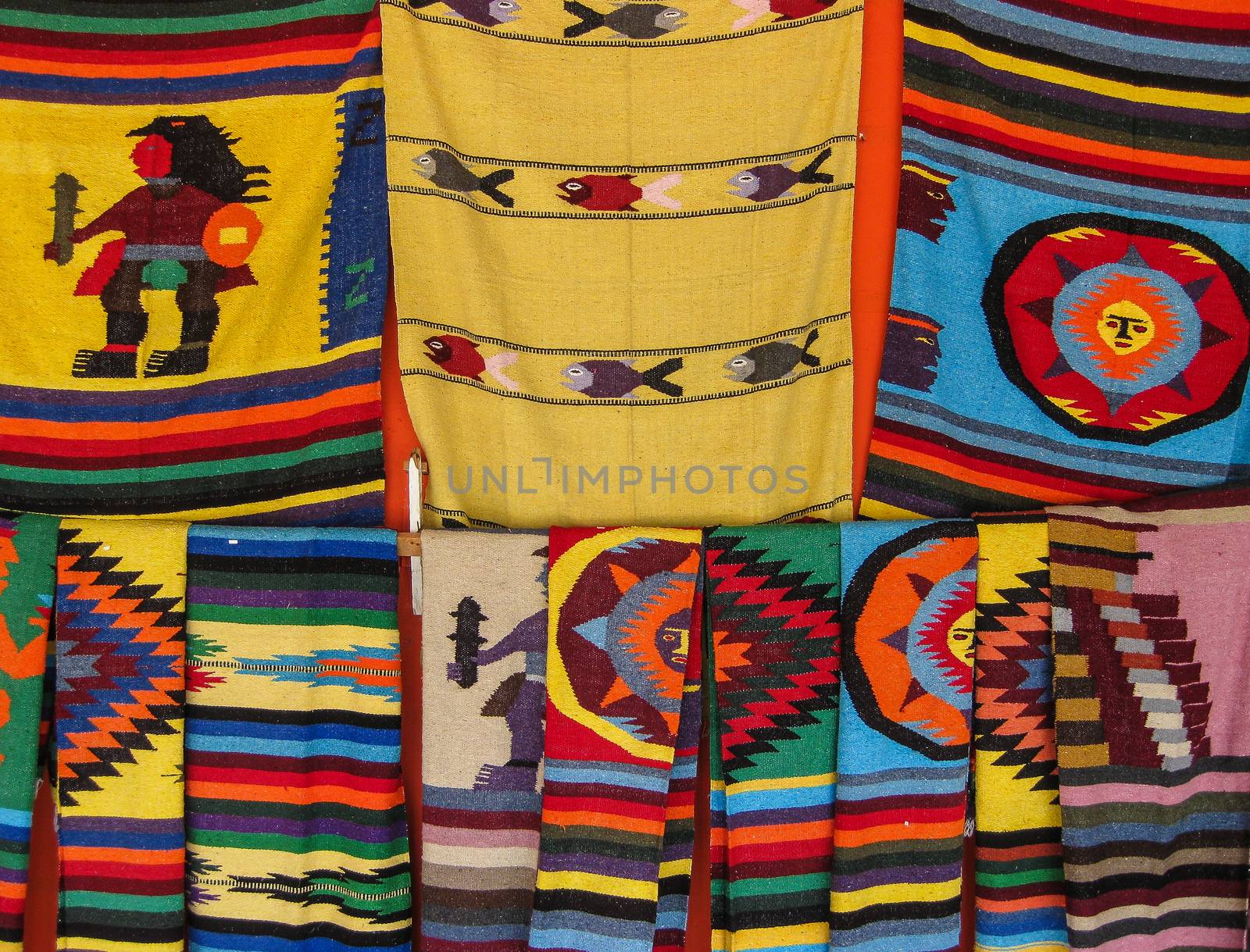 Mexican wool blankets with colorful designs and patterns for sale in the market in Yucatan, Mexico.