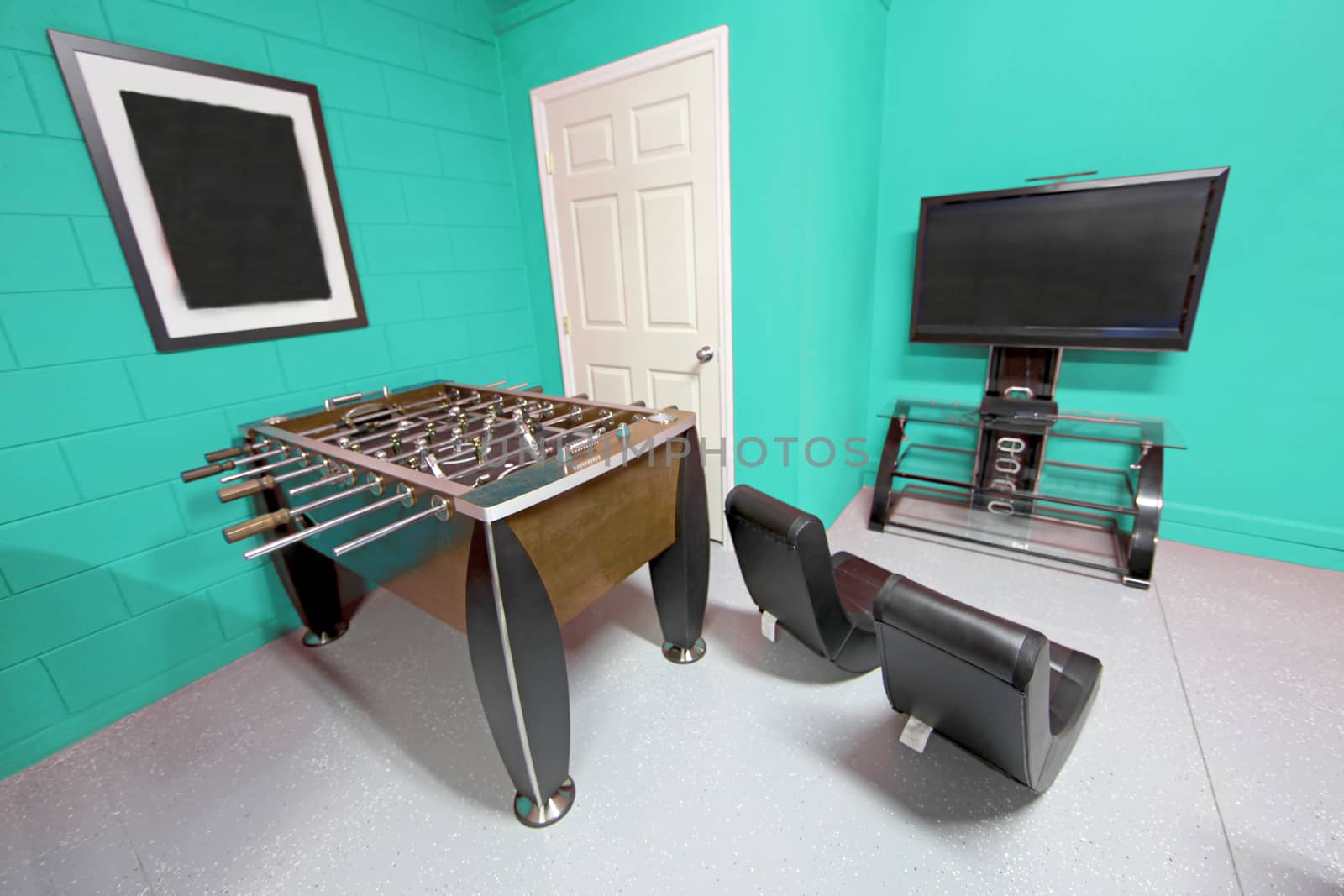 A Games Room with Foosball, TV and Gaming Chairs