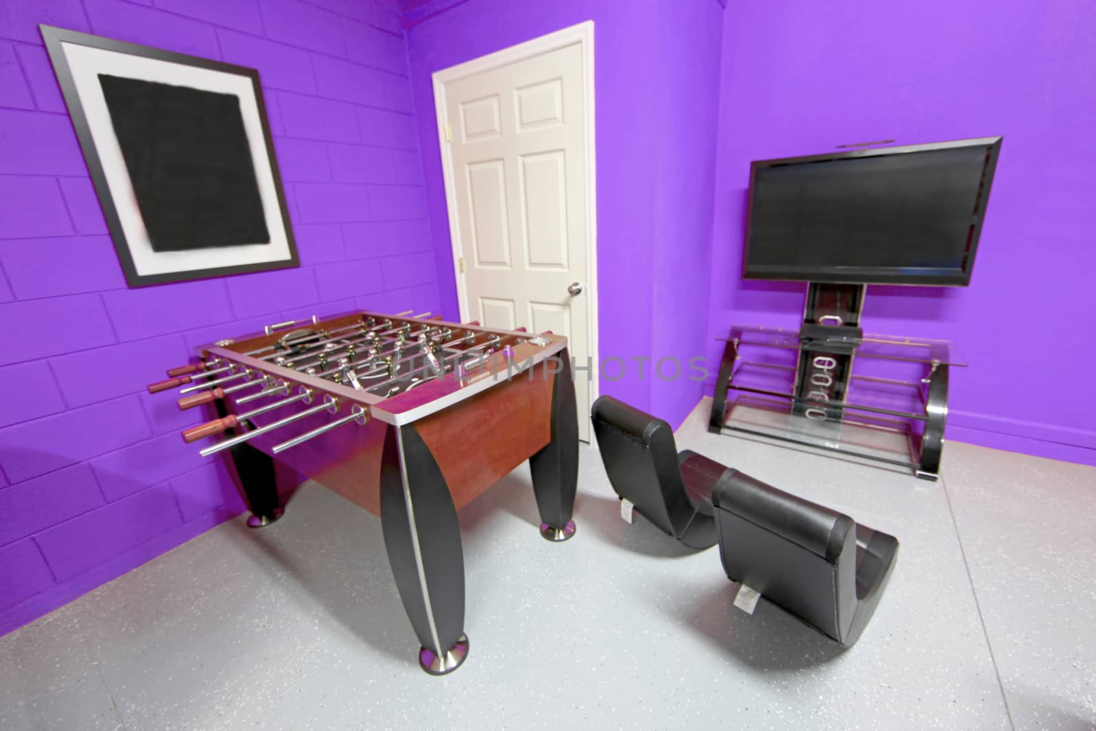 A Games Room with Foosball, TV and Gaming Chairs