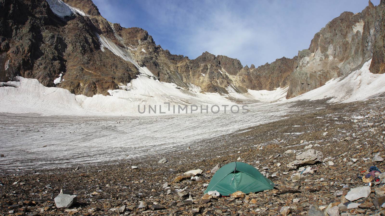 Green tent at glacier Greater Caucasus Mountain Range, North Osetia, Russia