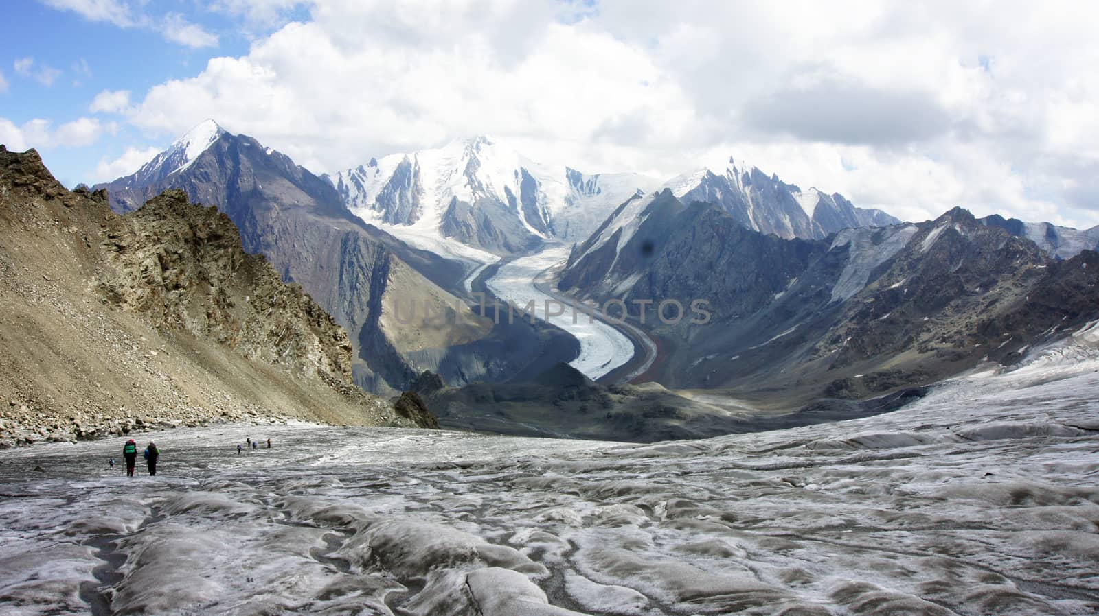 Trekkers at glacier Greater Caucasus Mountain Range, North Osetia, Russia