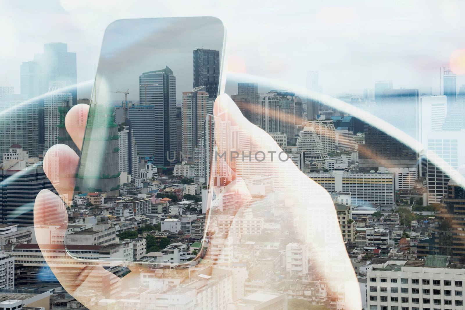 Double exposure of man using smart phone and cityscape background, urban lifestyle and Business technology concept.