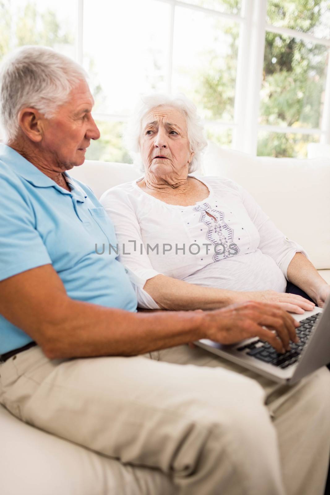 Focused senior couple using laptop by Wavebreakmedia