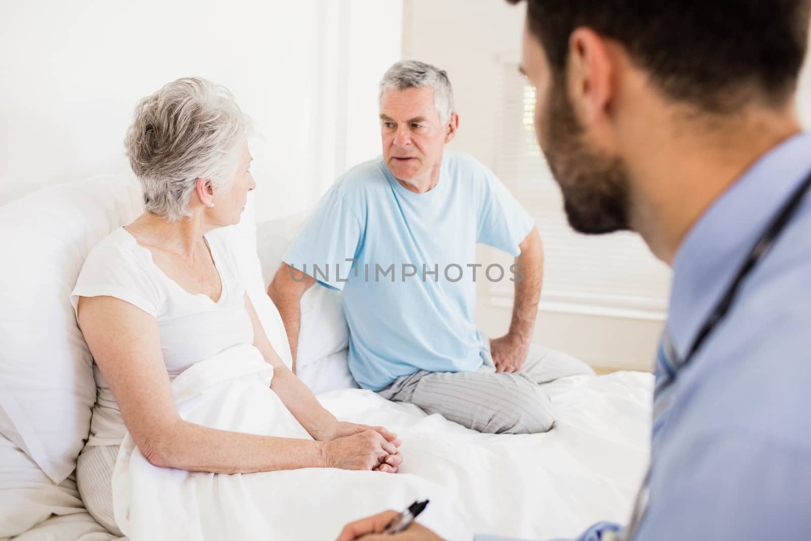 Handsome nurse visiting a mature woman at home
