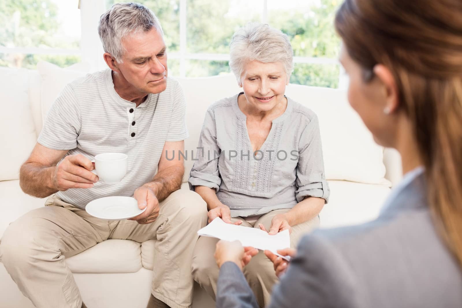 Businesswoman showing documents to senior couple by Wavebreakmedia