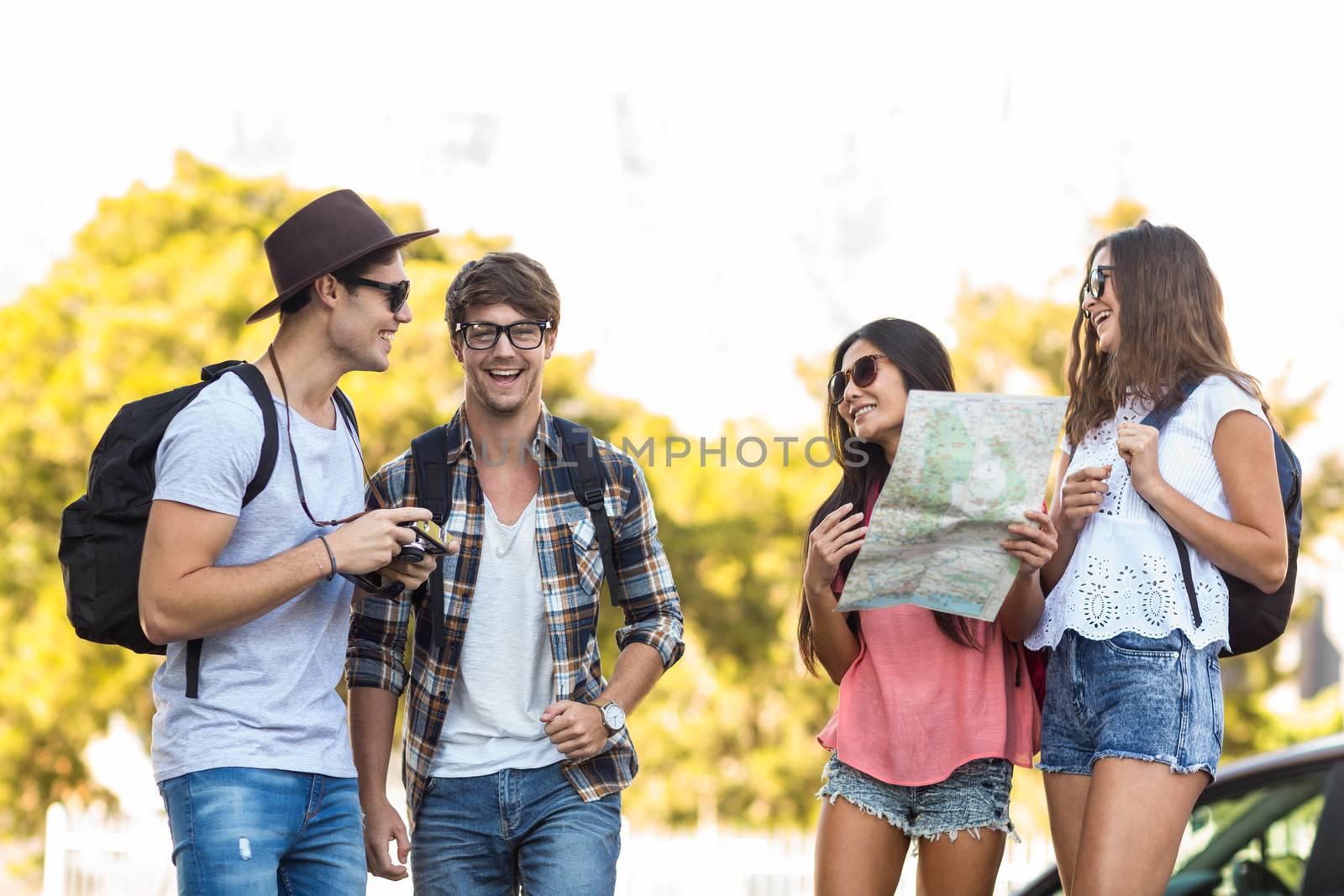 Hip friends checking map during a trip