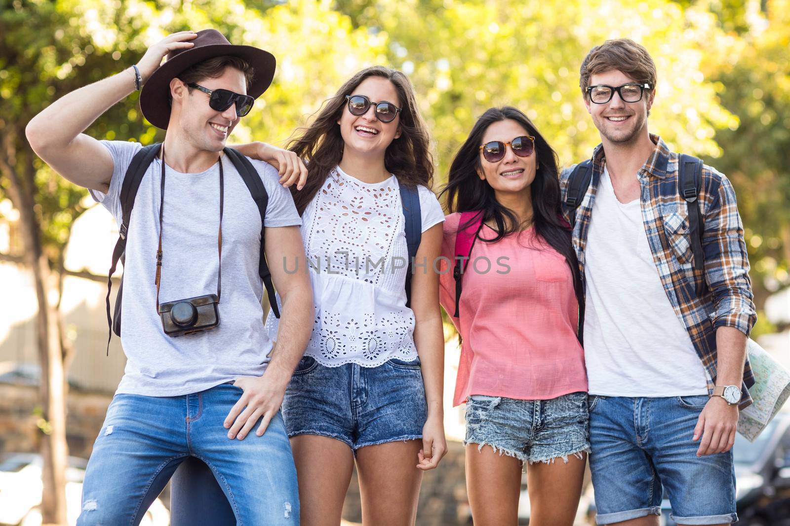 Hip friends posing for the camera outdoors during a trip