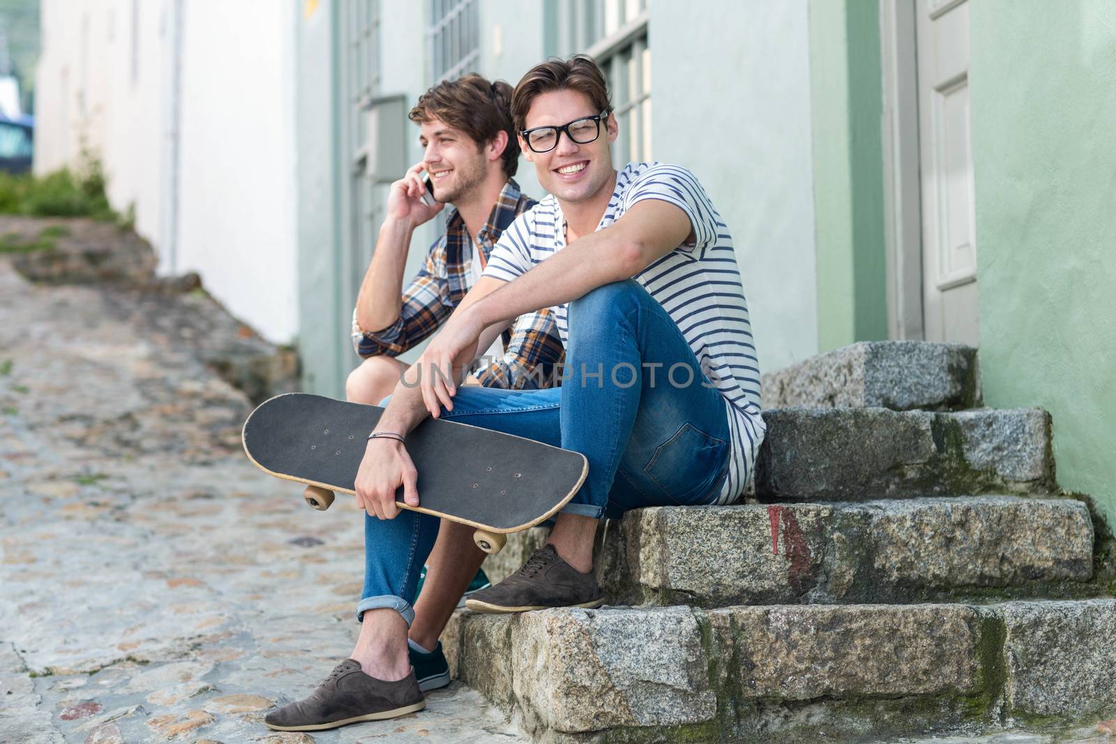 Hip men sitting on steps in the city