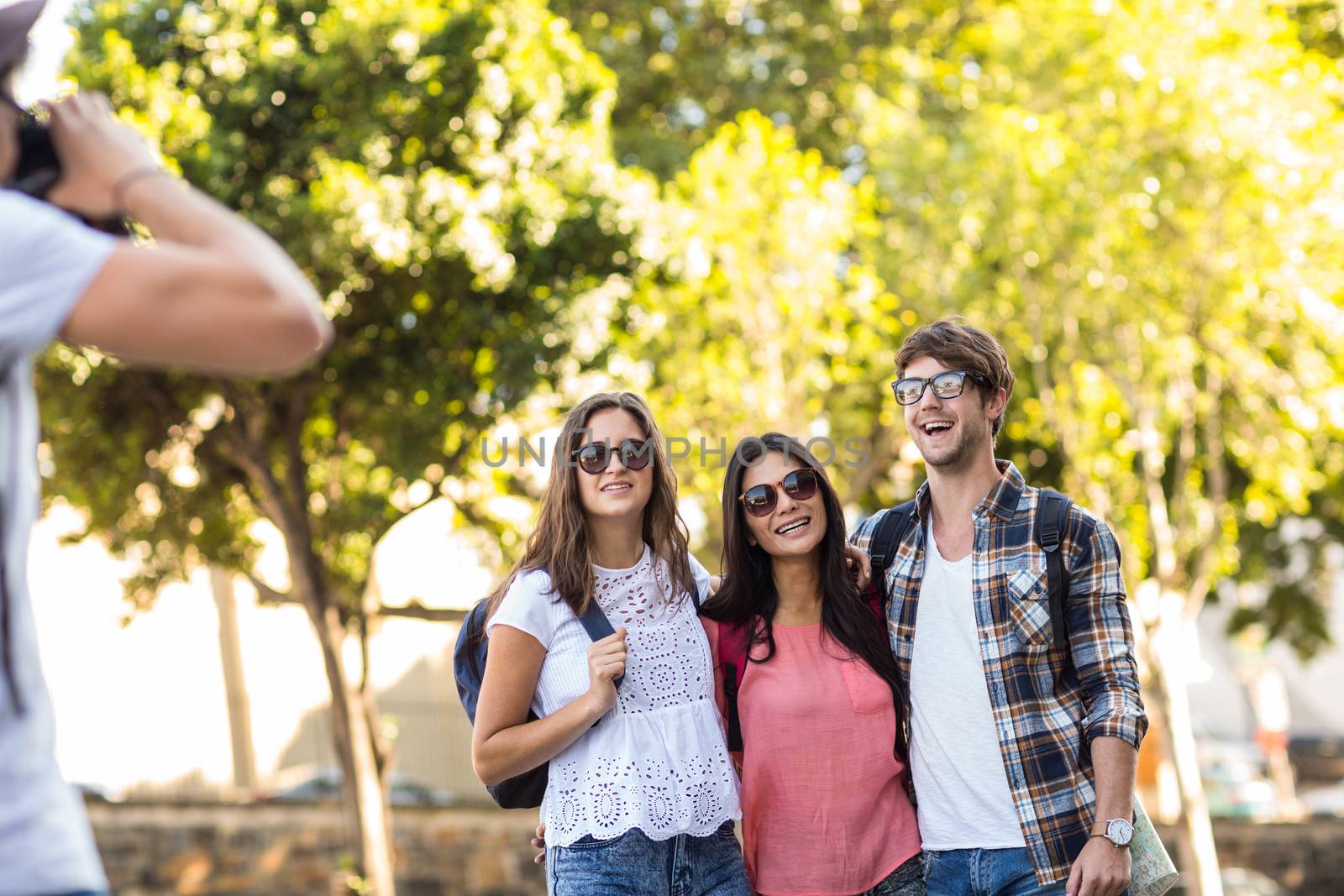 Hip man taking picture of his friends outdoors