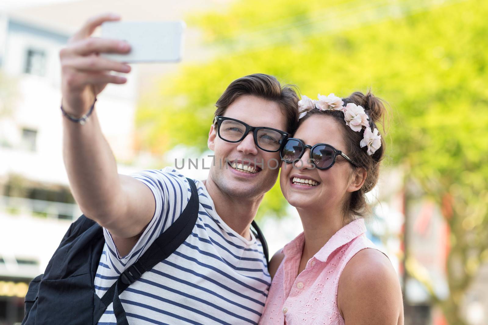 Hip couple taking selfie on the street