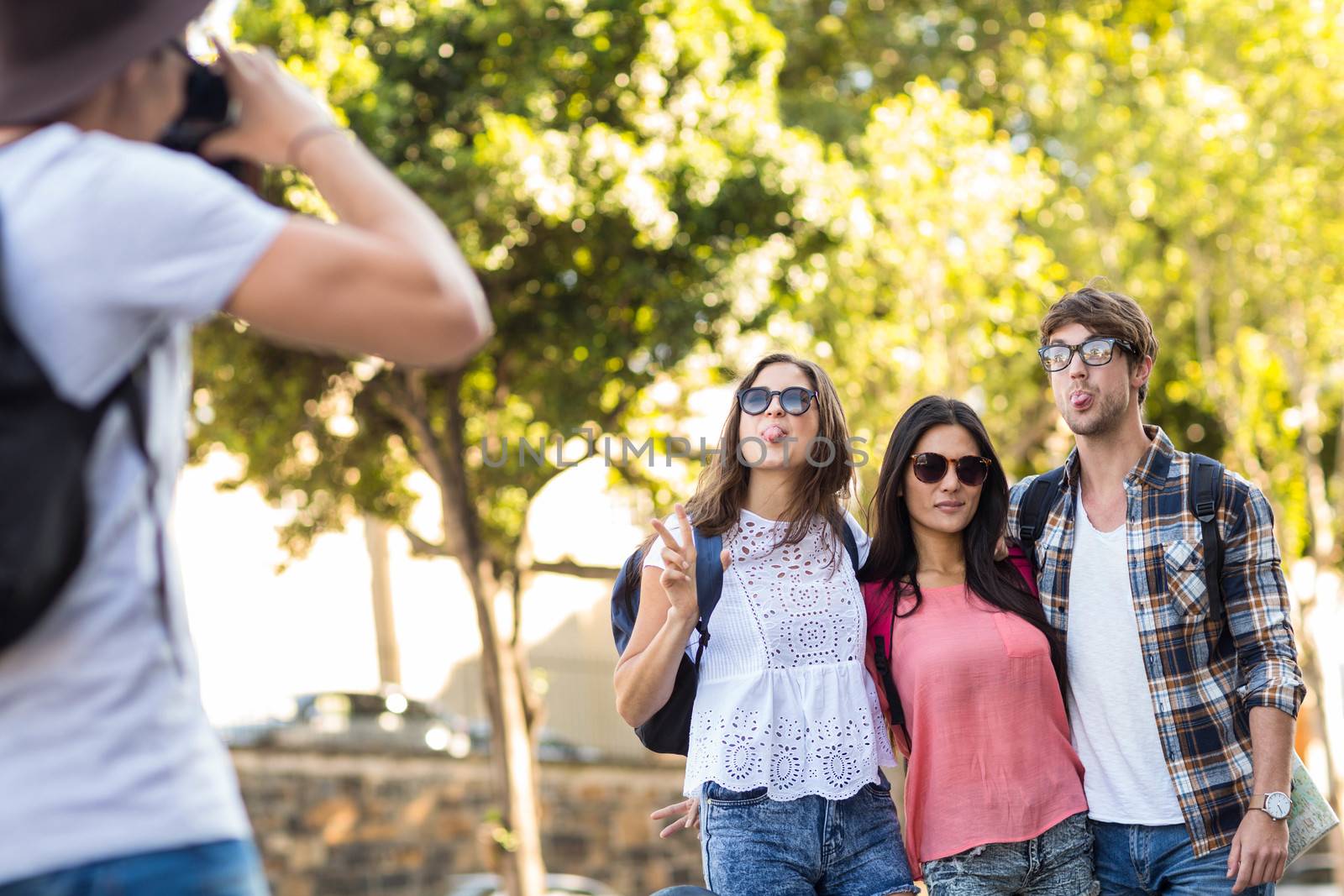 Hip man taking picture of his friends outdoors