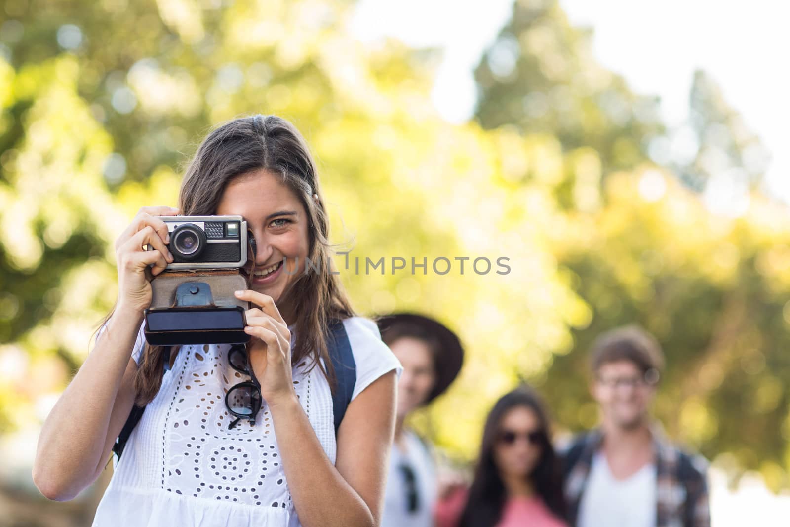 Hip woman taking picture of the camera outdoors