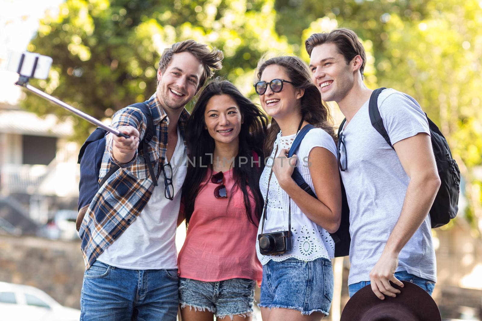 Hip friends taking selfie outdoors