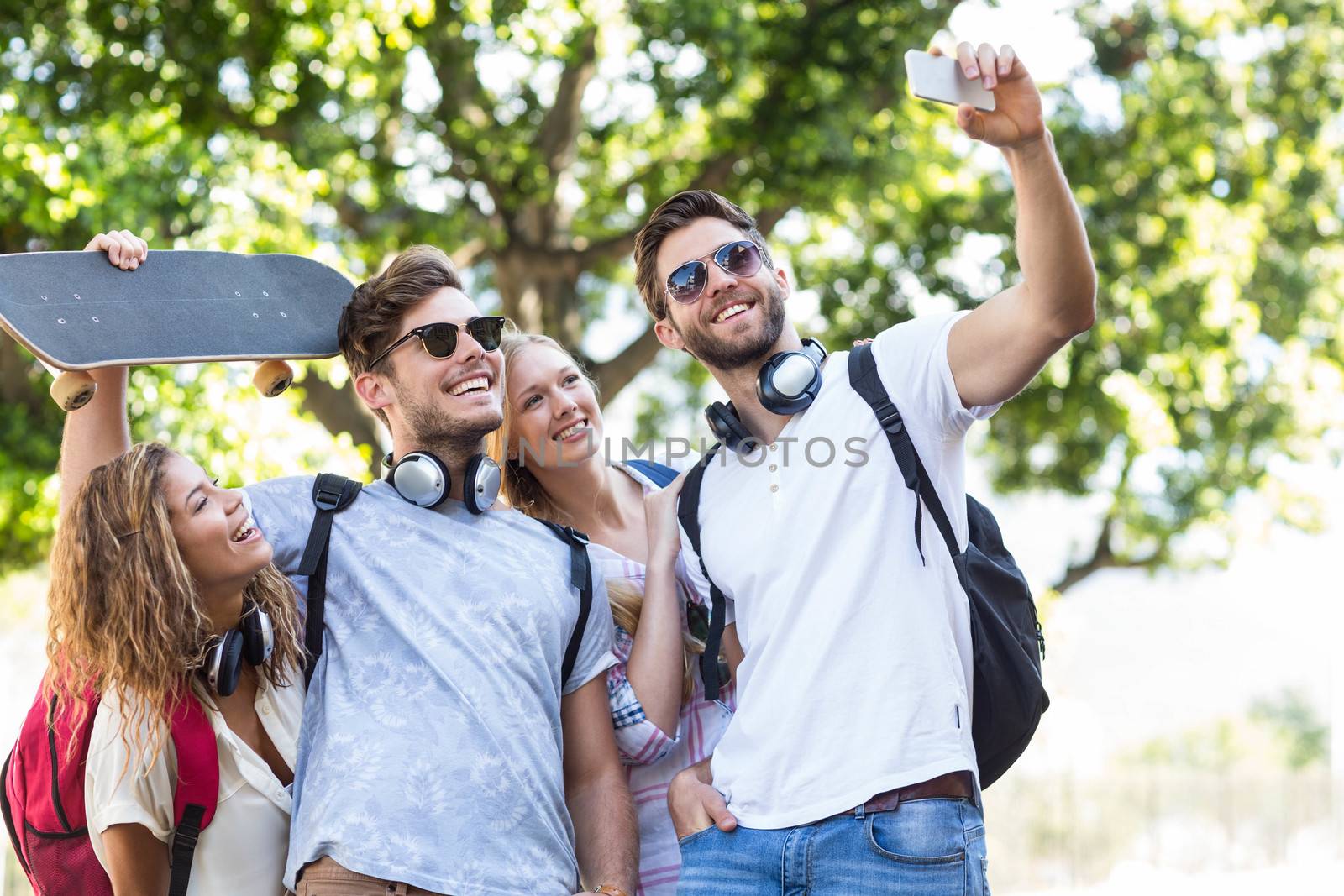 Hip friends taking selfie outdoors