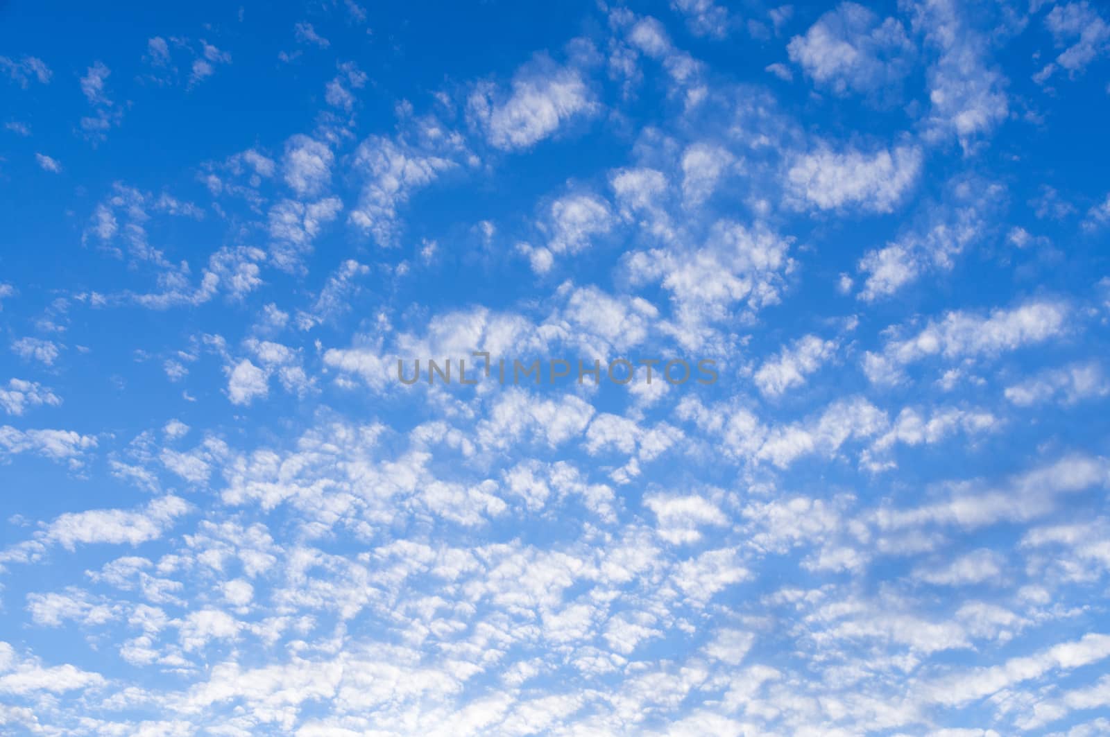 The photograph shows a sky with clouds