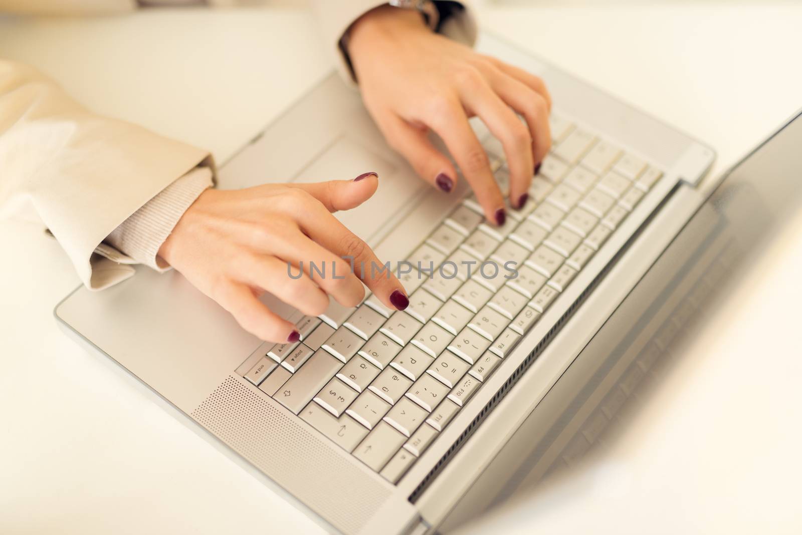 Close-up of female hand on the keyboard of the laptop.