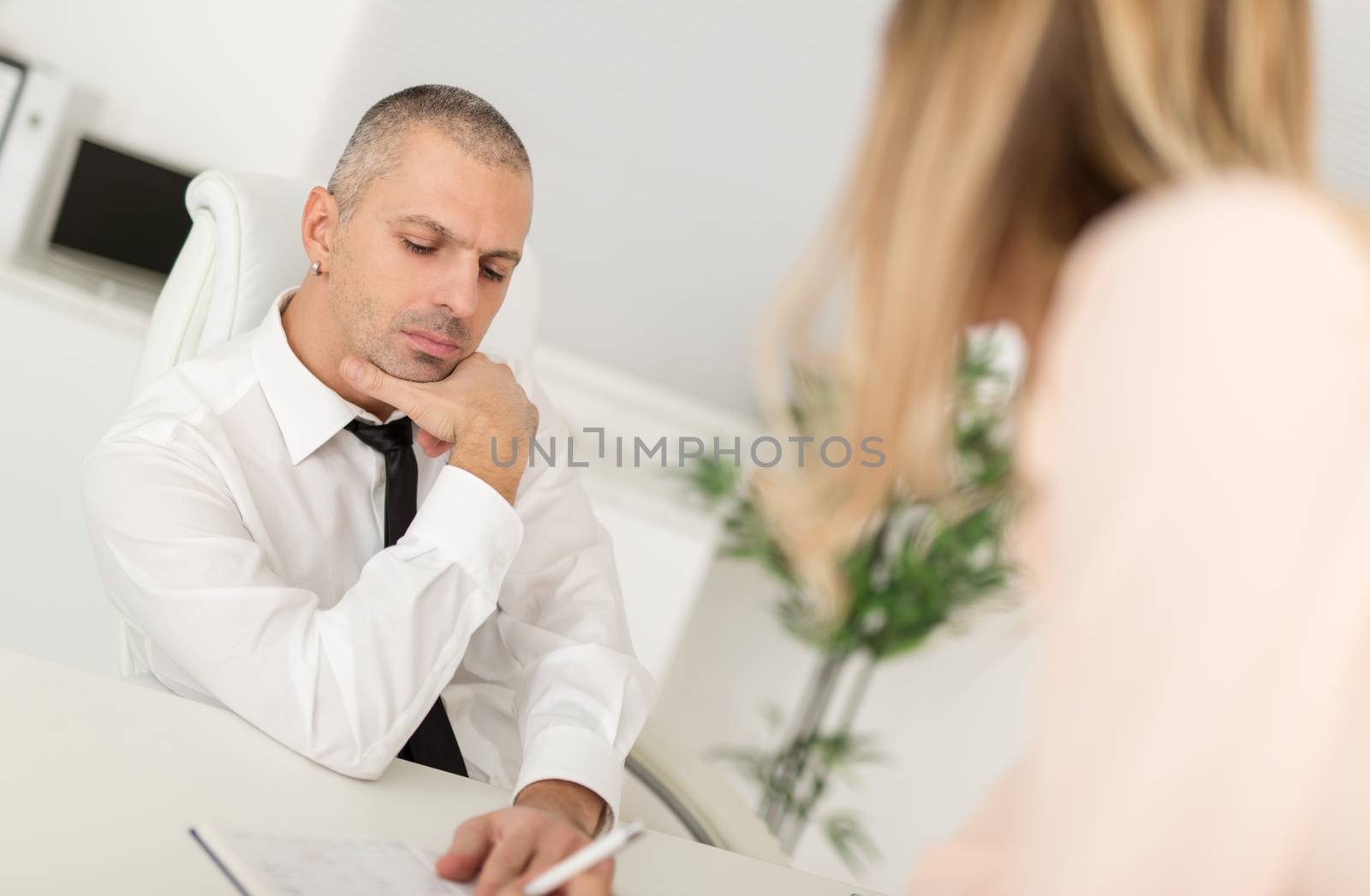 Businessman discussing plan with his female colleague in the office.