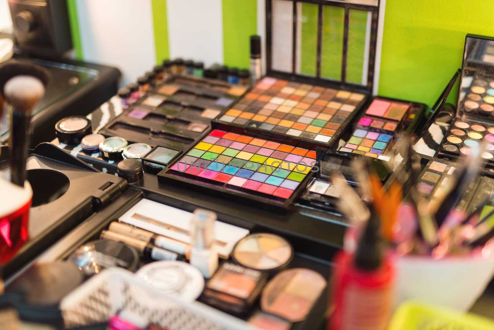 Close-up of a  various makeup items arranged for use by professional make-up artist . Selective focus.