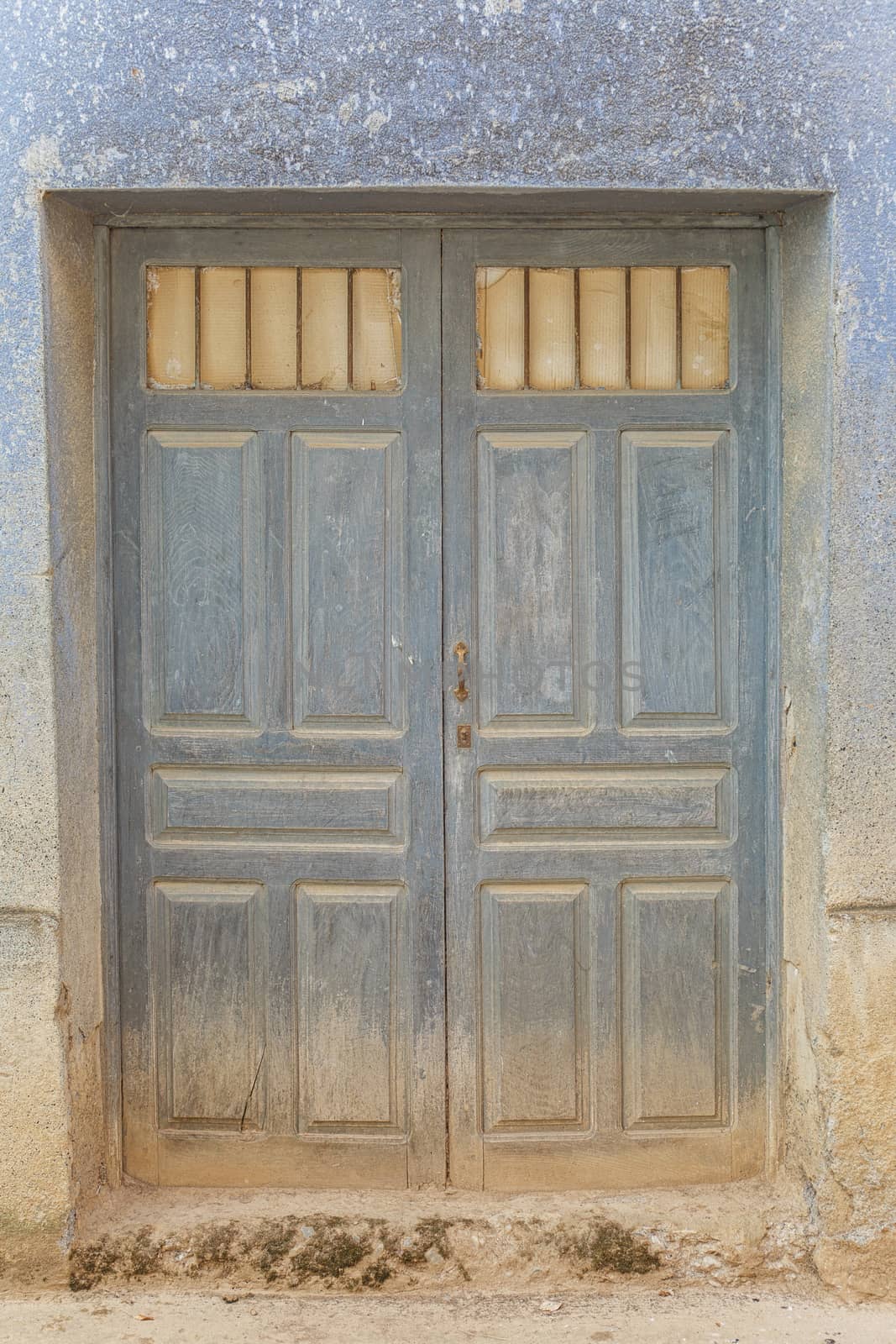 Old rustic wooden door covered in dust