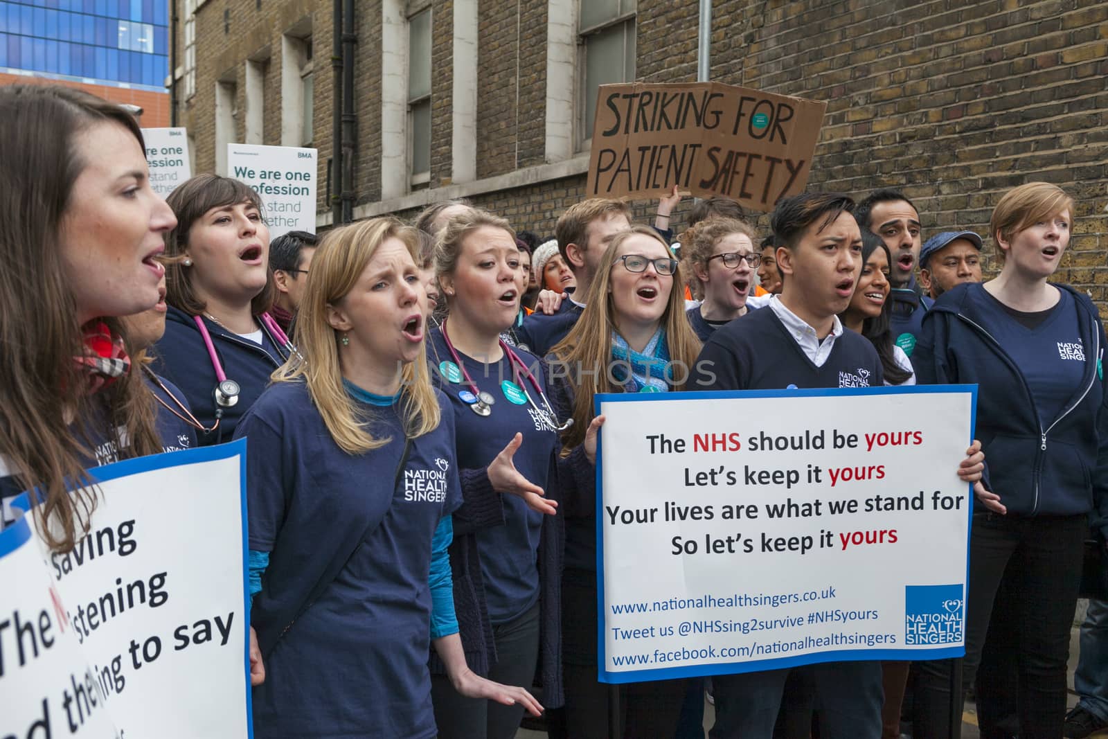 ENGLAND, London: Junior Doctors picket and hold signs during a demonstration outside Royal London Hospital on February 10, 2016, in London. The strike claim's the doctors would be over-worked which would lead to patients being endangered.  