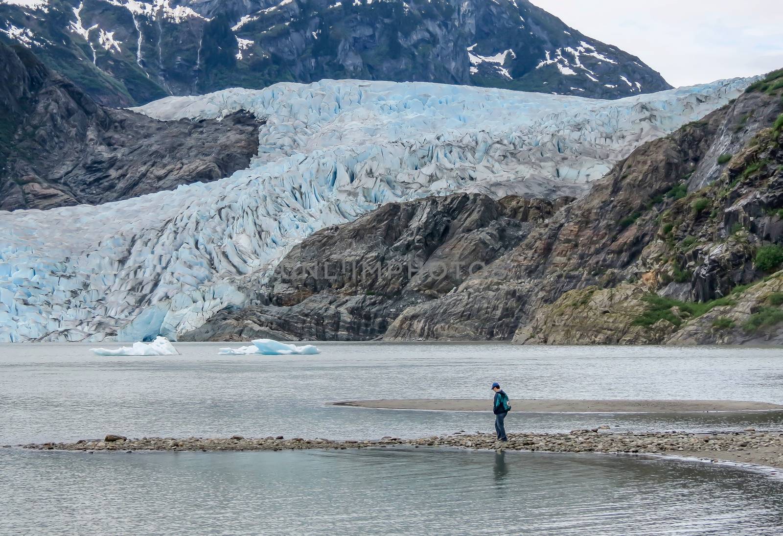 A tourist exploring the shoreline at the lake near Mendenhall Glacier at Juneau, Alaska.
Photo taken on: June 17th, 2012