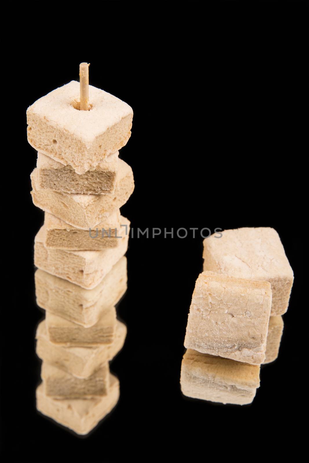 Homemade marshmallows on black backgrouns. by CatherineL-Prod