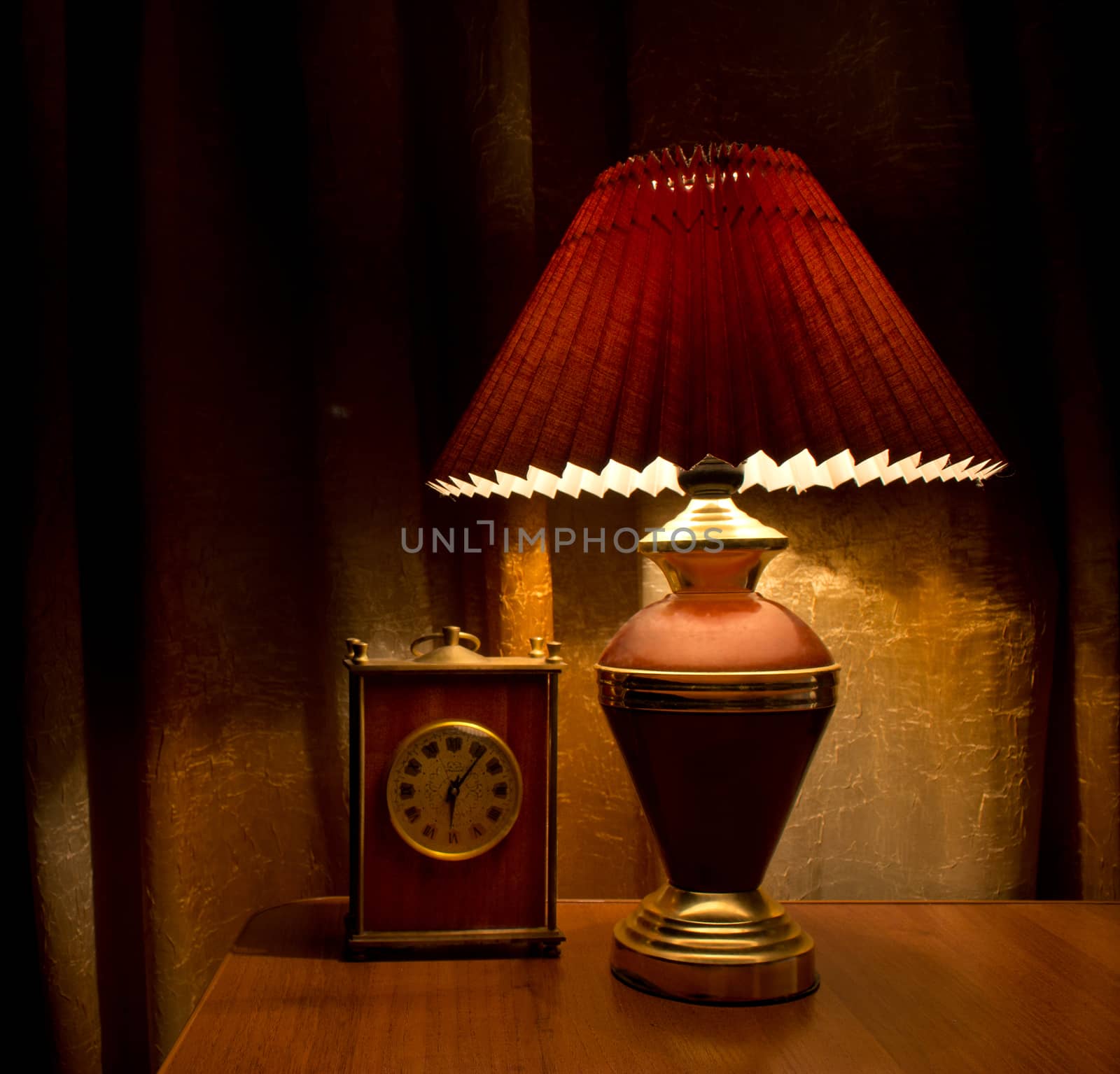 Old lamp and clock on the table
