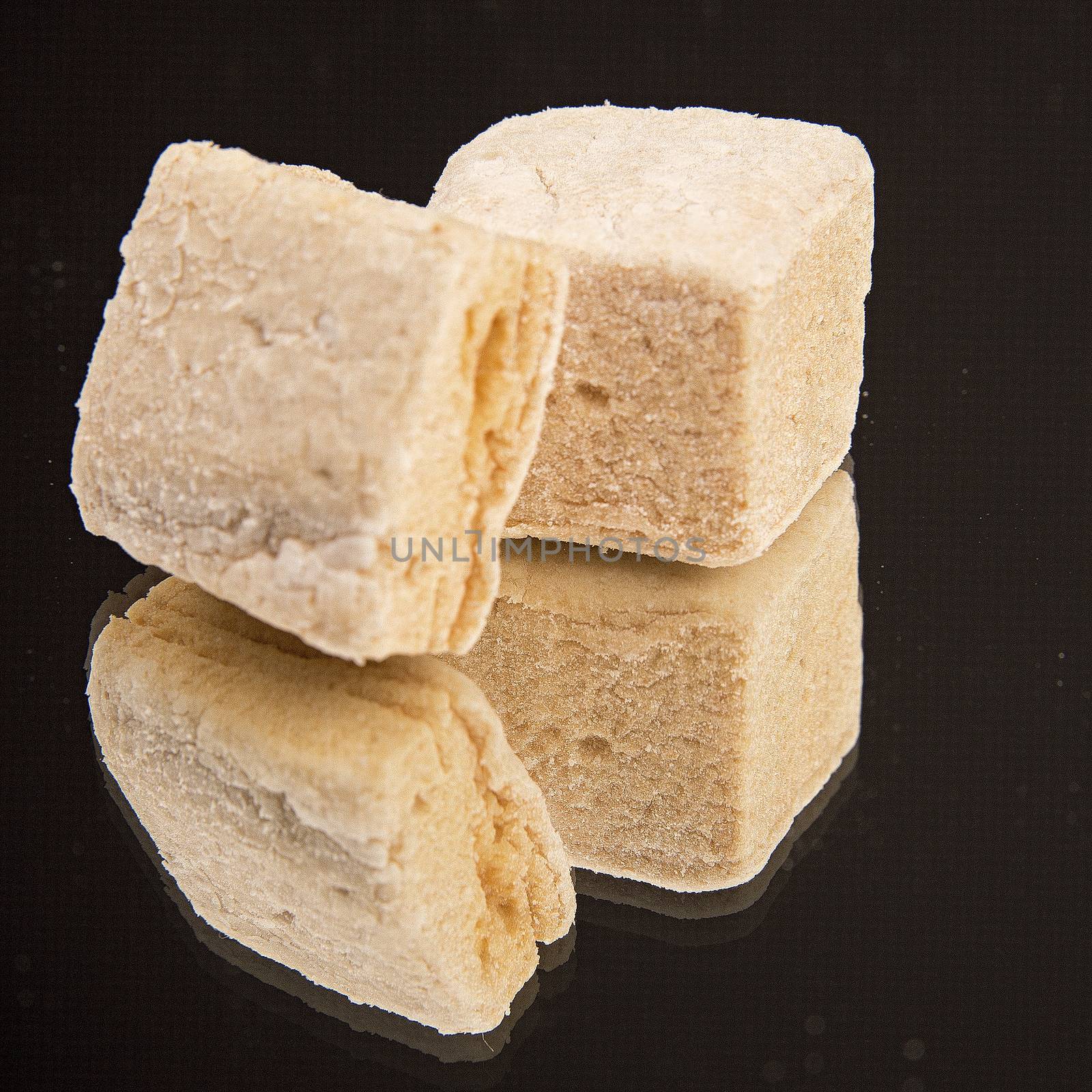 Homemade marshmallows on black backgrouns. by CatherineL-Prod