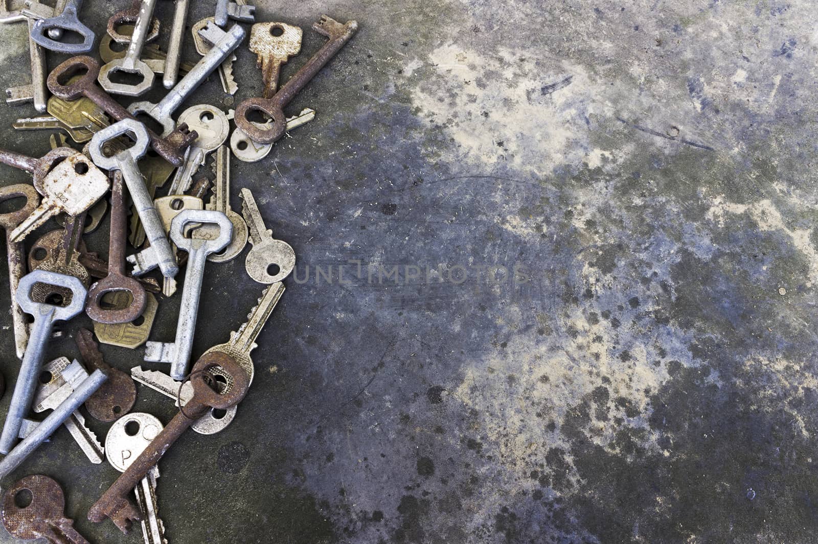 Old different keys, long unused, on the rustic background