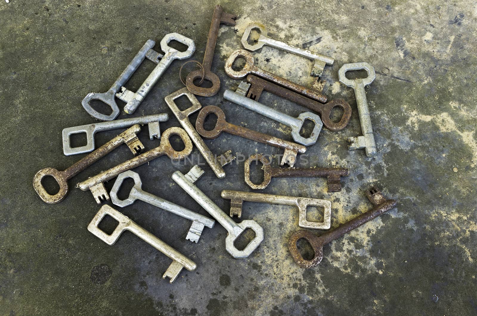 Old different keys, long unused, on the rustic background