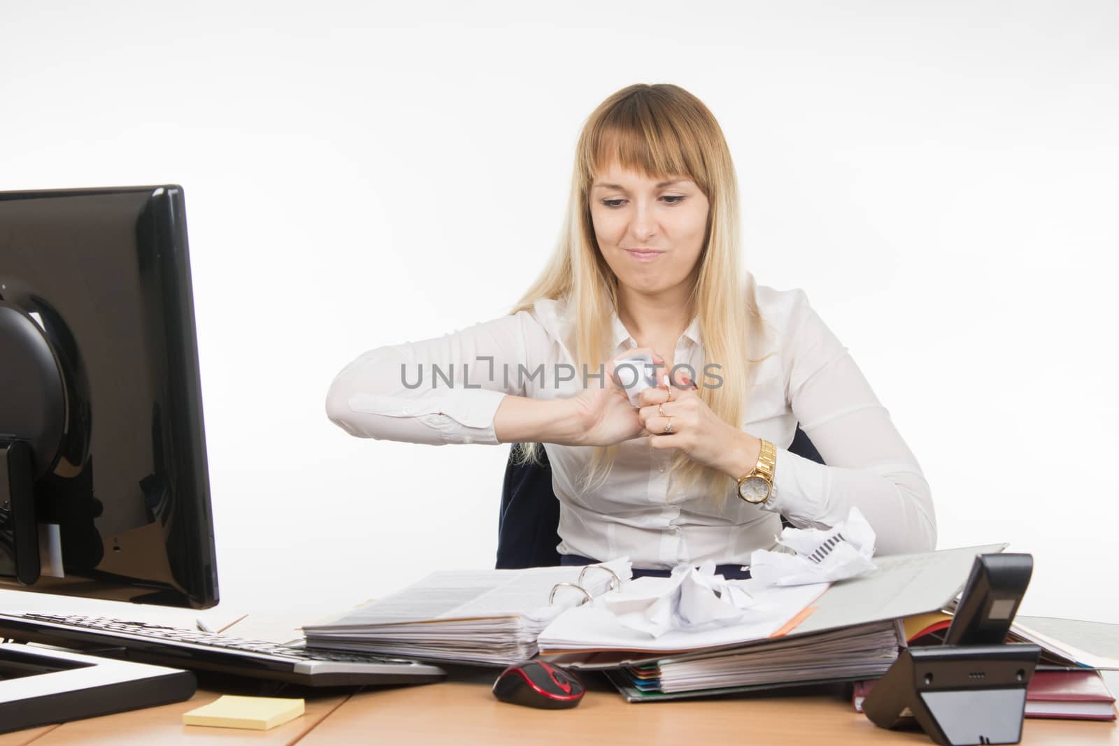 young beautiful business woman sitting at office desk working, isolated on white background