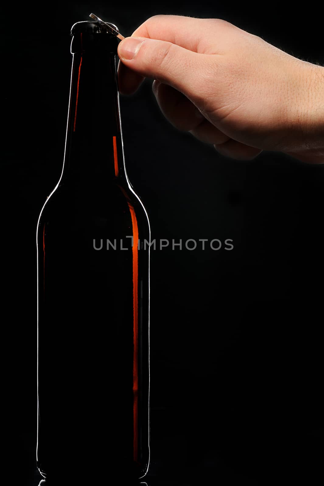 Open bottle beer hand black background brown