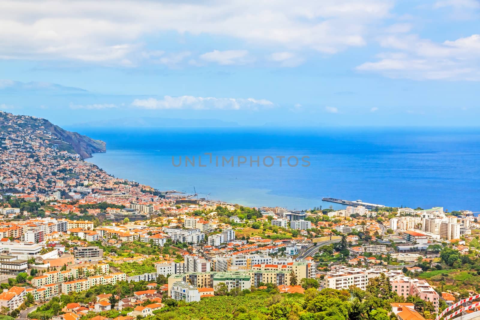 Funchal, Madeira - June 7, 2013: South coast of Funchal -view over the capital city of Madeira towards harbor. View from Pico dos Barcelo - Atlantic Ocean in the background.
