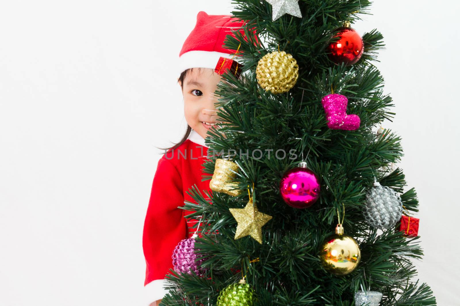 Asian Chinese little girl posing with Christmas Tree by kiankhoon