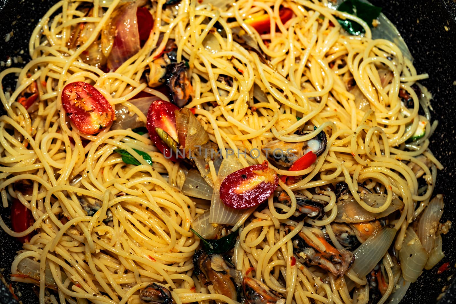 Fresh and spicy seafood pasta in a pan