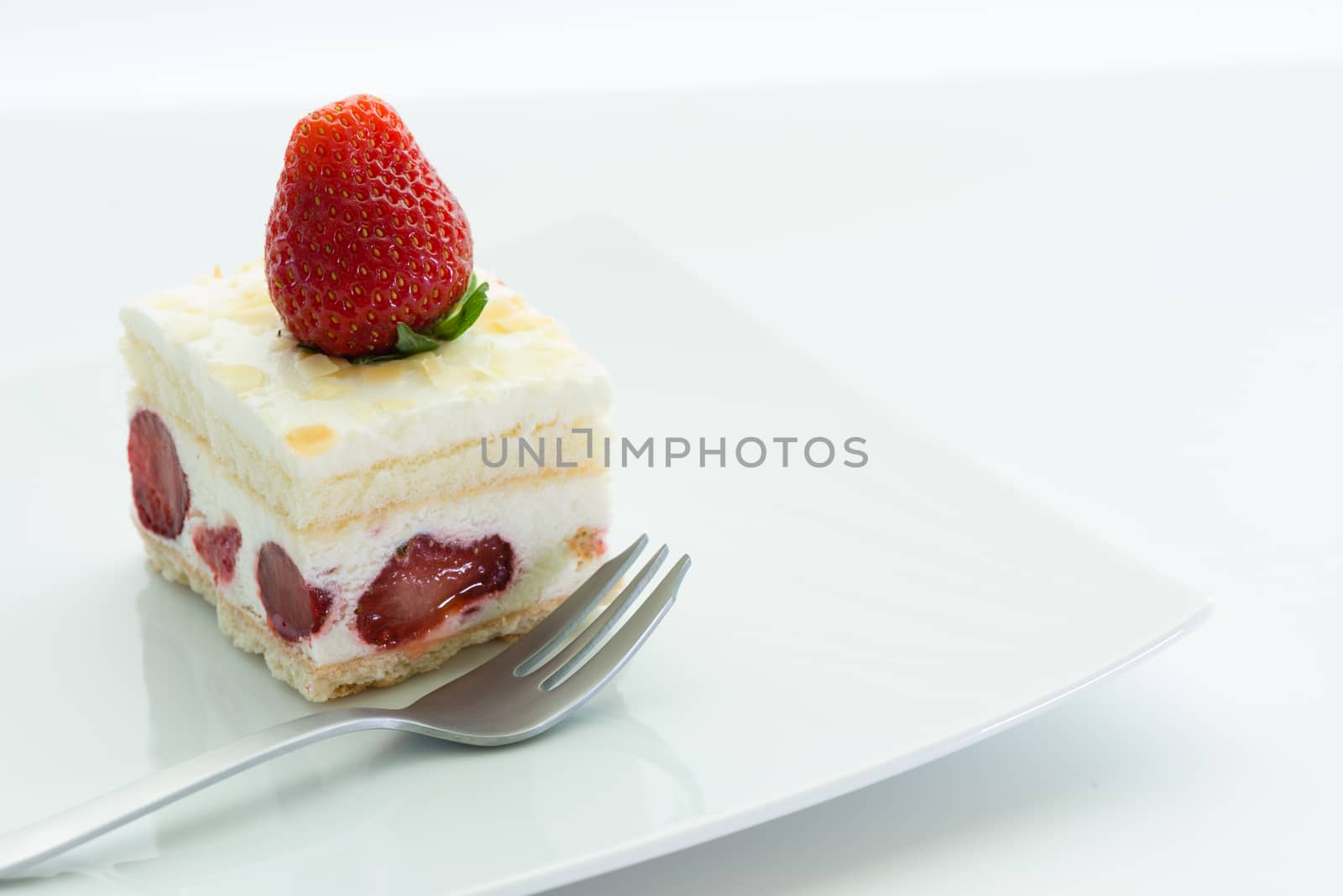 Dessert - sweet strawberry cake on white plate