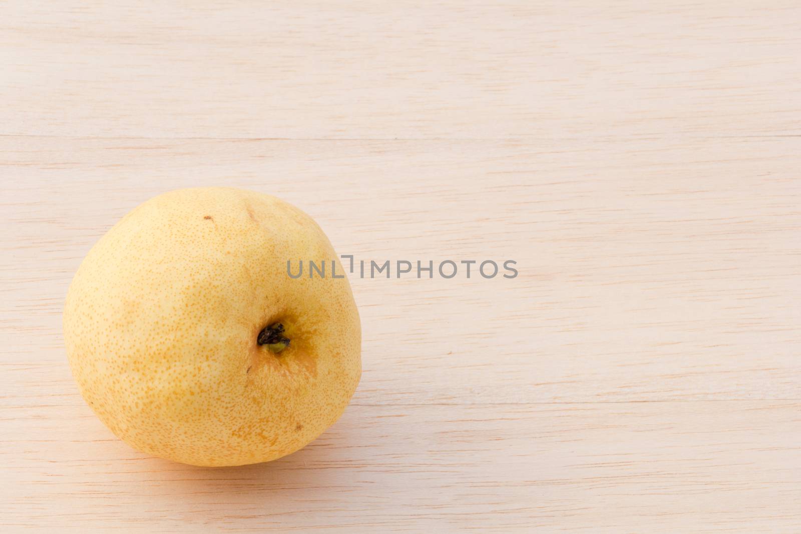 Asian pear on wood background by chingraph