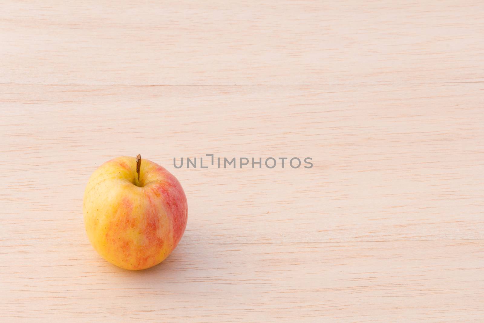 fuji apple on wood background by chingraph