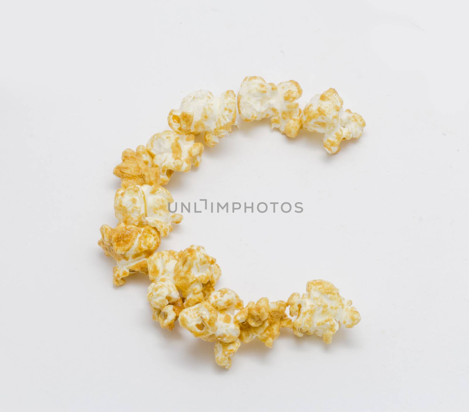 pop corn forming letter C isolated on white background